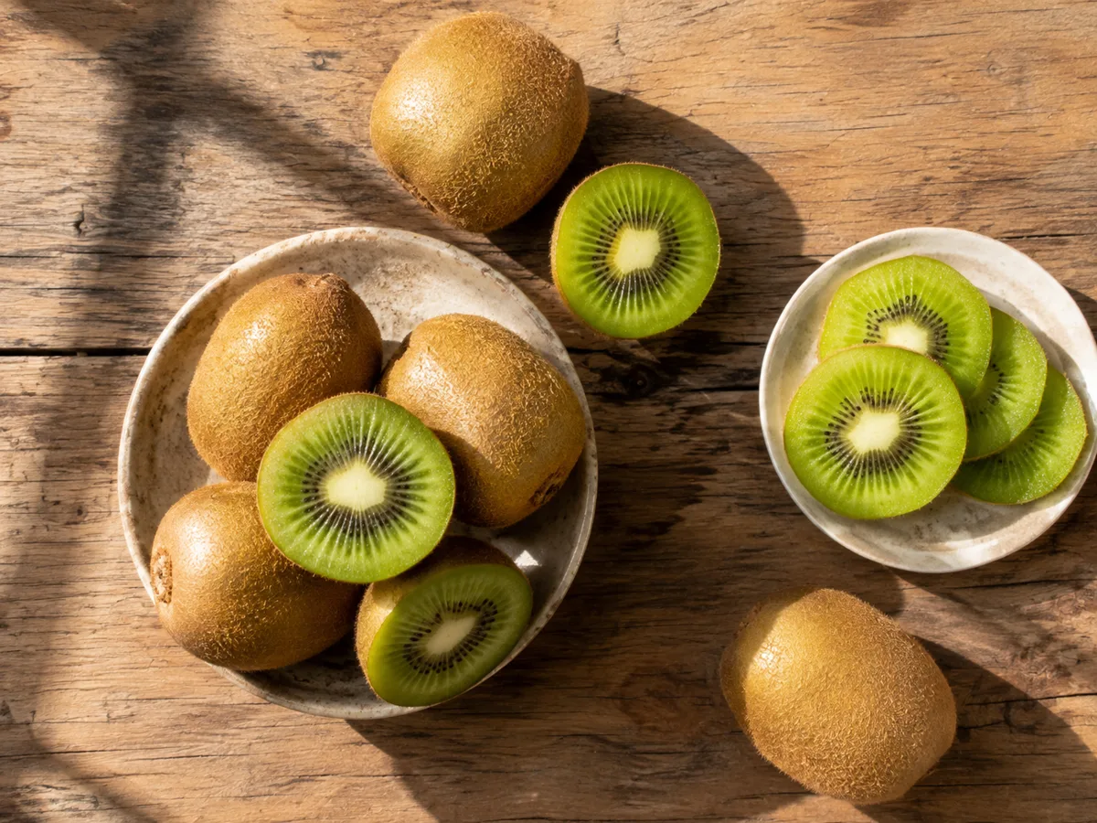 Sliced green kiwi fruit on a plate for a blood pressure-friendly food guide.